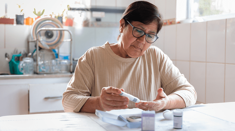 Woman checking blood sugar at home