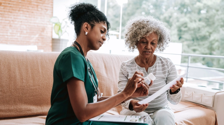 Healthcare professional discussing medication with patient.
