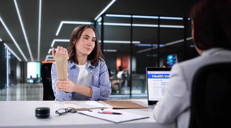 Woman with arm brace discussing insurance