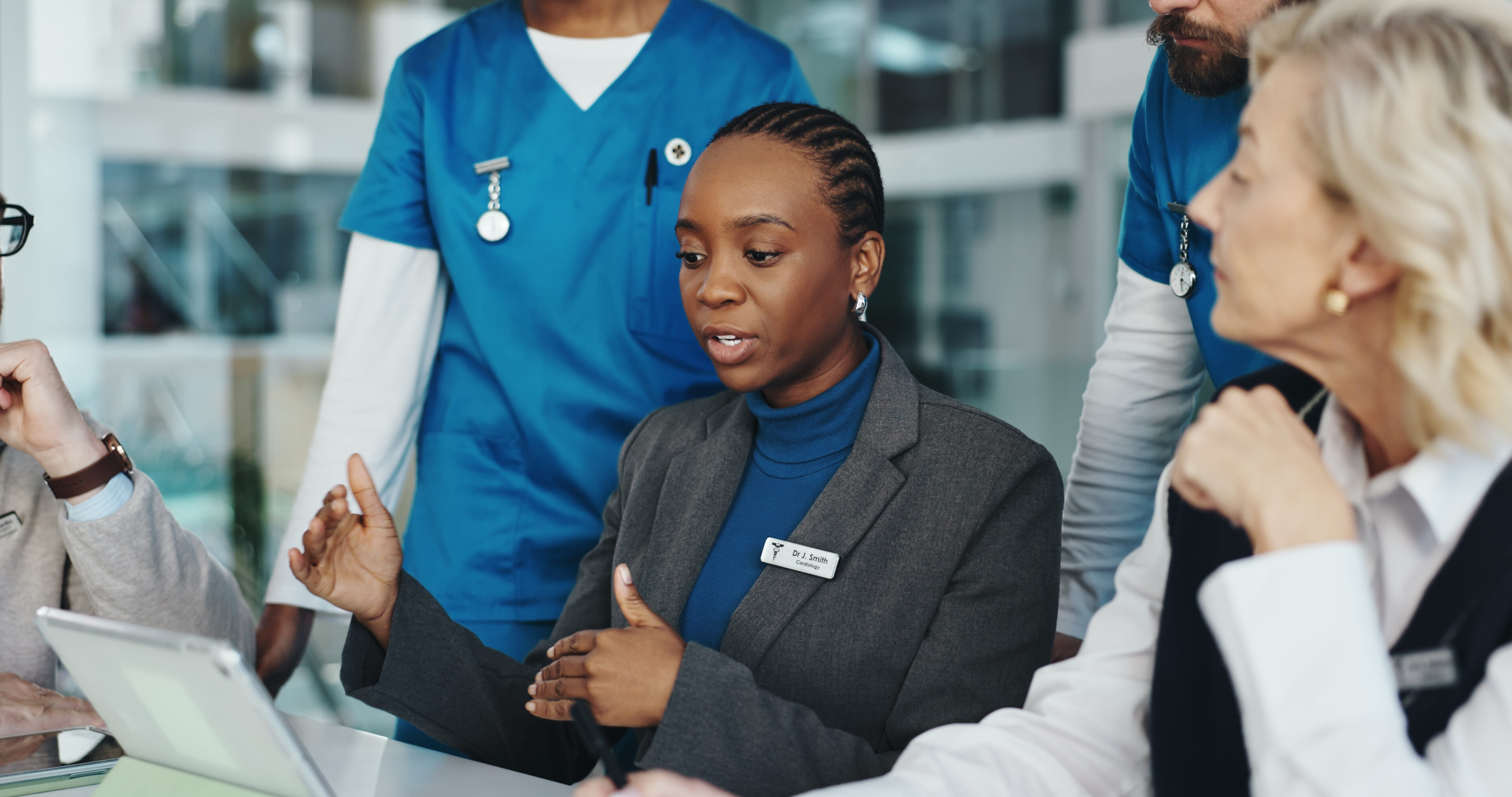Doctors, nurses or meeting with tablet in hospital for surgery schedule, task delegation or planning. Medical staff, people and feedback with tech for clinic management, healthcare cost and teamwork